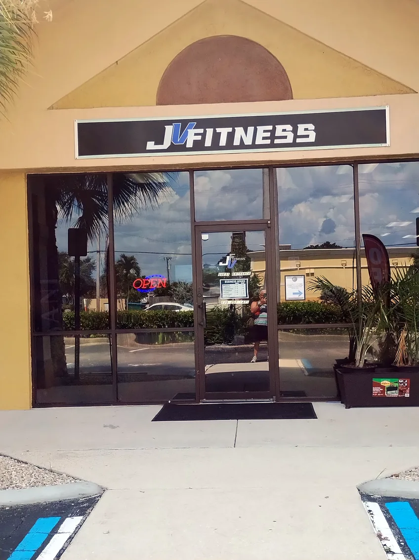 Arched entrance of JV Fitness with the black JV FITNESS sign