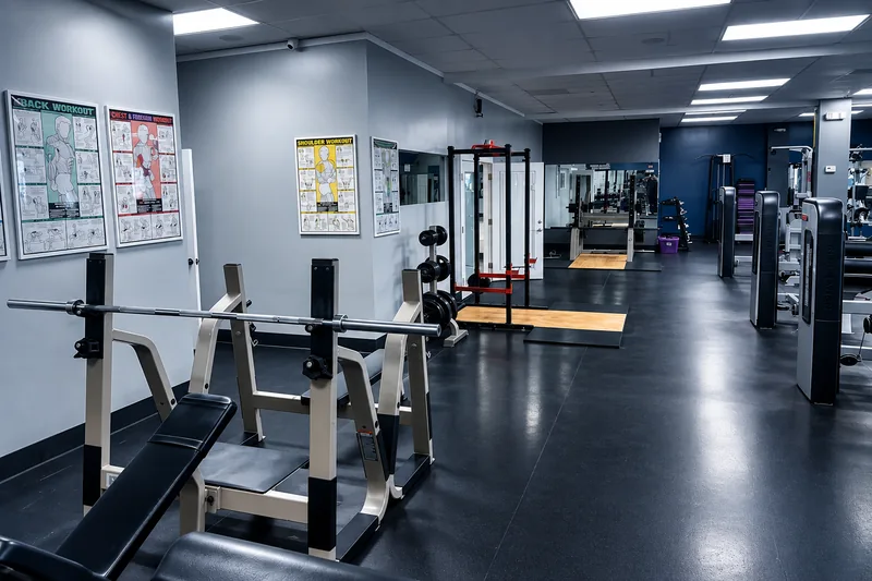 Squat rack and benches next to plate-loaded machines